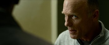 Movie still from “Cleaner” (2007), directed by Renny Harlin – An older man looking into a mirror with blue eyes; Close Up shot, Over the shoulder angle