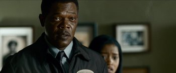 Movie still from “Cleaner” (2007), directed by Renny Harlin – A man and a woman standing next to each other in a room; Close Up shot, Over the shoulder angle