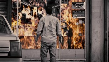 Movie still from “Clerks II” (2006), directed by Kevin Smith – A man standing in front of a wall of fire; Wide shot, Low angle