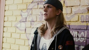 Movie still from “Clerks II” (2006), directed by Kevin Smith – A man with long blonde hair wearing a hat; Close Up shot, Low angle