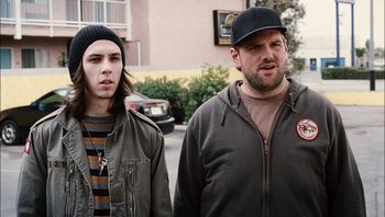 Movie still from “Clerks II” (2006), directed by Kevin Smith – Two men standing next to each other on the sidewalk; Close Up shot, Over the shoulder angle