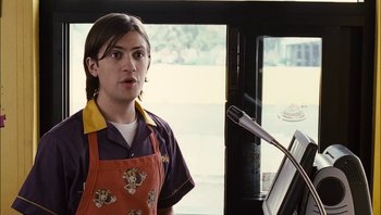 Movie still from “Clerks II” (2006), directed by Kevin Smith – A person standing in front of a microphone; Medium shot, Low angle