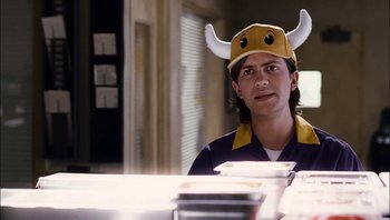 Movie still from “Clerks II” (2006), directed by Kevin Smith – A person wearing a hat with horns on it; Close Up shot, Over the shoulder angle