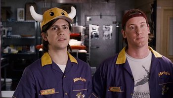 Movie still from “Clerks II” (2006), directed by Kevin Smith – A couple of men standing next to each other in a room; Medium shot, High angle