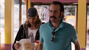 Movie still from “Clerks II” (2006), directed by Kevin Smith – A man and a woman are standing next to each other; Medium shot, Over the shoulder angle