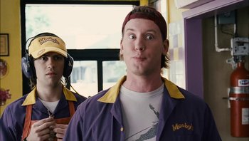 Movie still from “Clerks II” (2006), directed by Kevin Smith – A man in a purple and yellow jacket and a man in a red and yellow hat; Close Up shot, Over the shoulder angle