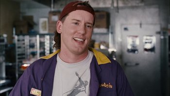 Movie still from “Clerks II” (2006), directed by Kevin Smith – A man in a purple jacket and a red hat; Close Up shot, Over the shoulder angle