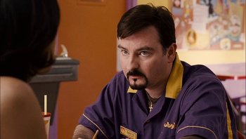 Movie still from “Clerks II” (2006), directed by Kevin Smith – A person sitting at a table; Close Up shot, Over the shoulder angle