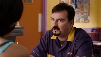 Movie still from “Clerks II” (2006), directed by Kevin Smith – A person sitting at a table; Close Up shot, Over the shoulder angle