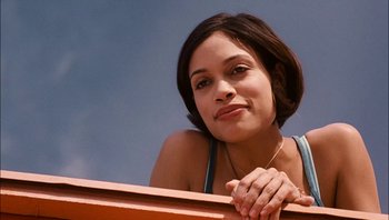 Movie still from “Clerks II” (2006), directed by Kevin Smith – A woman leaning on a wooden railing looking to her left; Close Up shot, Low angle