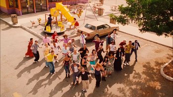 Movie still from “Clerks II” (2006), directed by Kevin Smith – A group of people standing on the side of the street; Extreme Wide shot, High angle