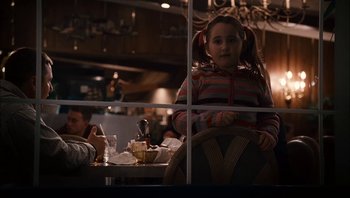 Movie still from “Clerks II” (2006), directed by Kevin Smith – A little girl sitting at a table in front of a window; Medium shot, Over the shoulder angle