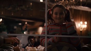 Movie still from “Clerks II” (2006), directed by Kevin Smith – A little girl sitting at a table in front of a window; Medium shot, Over the shoulder angle