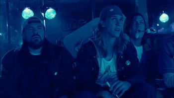 Movie still from “Clerks II” (2006), directed by Kevin Smith – A group of people sitting in a bus at night; Medium shot, Low angle