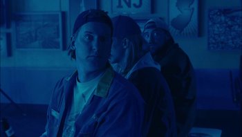 Movie still from “Clerks II” (2006), directed by Kevin Smith – A group of men standing next to each other in the dark; Medium shot, Low angle