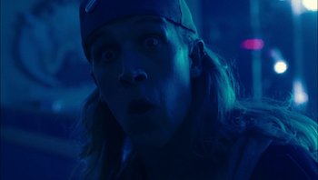 Movie still from “Clerks II” (2006), directed by Kevin Smith – A man with long blonde hair wearing a hat; Close Up shot, Low angle