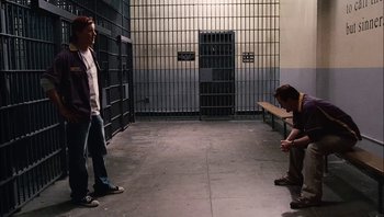 Movie still from “Clerks II” (2006), directed by Kevin Smith – Two men are standing in an empty jail cell; Wide shot, High angle
