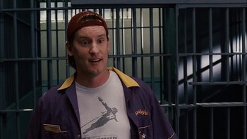 Movie still from “Clerks II” (2006), directed by Kevin Smith – A man wearing a hat and a shirt in front of bars; Close Up shot, Low angle