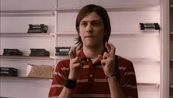 Movie still from “Clerks II” (2006), directed by Kevin Smith – A young man holding his hands up in the air; Medium shot, Over the shoulder angle