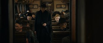 Movie still from “Cliff Walkers” (2021), directed by Yimou Zhang – A group of people sitting in a room; Medium shot, Over the shoulder angle