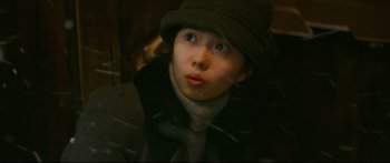 Movie still from “Cliff Walkers” (2021), directed by Yimou Zhang – A young boy wearing a hat and a coat; Close Up shot, Low angle