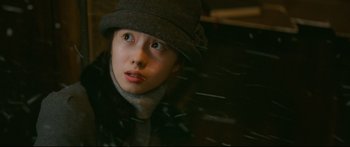 Movie still from “Cliff Walkers” (2021), directed by Yimou Zhang – A young woman wearing a hat and a sweater; Close Up shot, Over the shoulder angle
