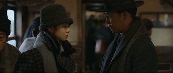 Movie still from “Cliff Walkers” (2021), directed by Yimou Zhang – A man and a woman talking to each other; Medium shot, Over the shoulder angle