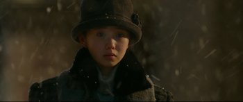 Movie still from “Cliff Walkers” (2021), directed by Yimou Zhang – A young boy wearing a coat and a hat; Close Up shot, Low angle