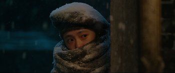 Movie still from “Cliff Walkers” (2021), directed by Yimou Zhang – A man wearing a hat and a fur coat; Close Up shot, Over the shoulder angle