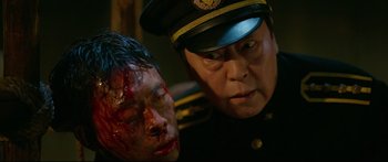 Movie still from “Cliff Walkers” (2021), directed by Yimou Zhang – A man in a police uniform and a man in a military uniform; Close Up shot, Over the shoulder angle