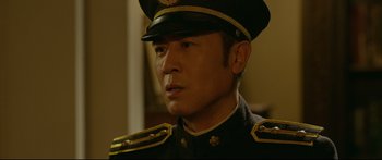Movie still from “Cliff Walkers” (2021), directed by Yimou Zhang – A person wearing a uniform; Close Up shot, Over the shoulder angle