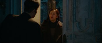 Movie still from “Cliff Walkers” (2021), directed by Yimou Zhang – A young woman standing in front of a man in front of a building; Medium shot, Over the shoulder angle