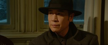 Movie still from “Cliff Walkers” (2021), directed by Yimou Zhang – A person wearing a hat; Close Up shot, Low angle