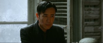 Movie still from “Cliff Walkers” (2021), directed by Yimou Zhang – A person wearing a suit and tie; Close Up shot, Over the shoulder angle
