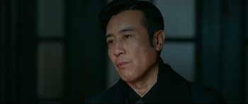Movie still from “Cliff Walkers” (2021), directed by Yimou Zhang – A person wearing a black shirt; Close Up shot, Low angle