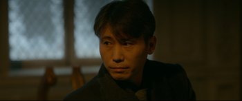 Movie still from “Cliff Walkers” (2021), directed by Yimou Zhang – A person wearing a jacket; Close Up shot, Over the shoulder angle