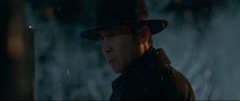 Movie still from “Cliff Walkers” (2021), directed by Yimou Zhang – A man wearing a hat and a black jacket; Close Up shot, Low angle