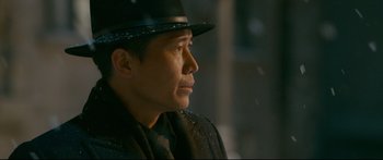 Movie still from “Cliff Walkers” (2021), directed by Yimou Zhang – A man wearing a black hat and a black coat; Close Up shot, Low angle