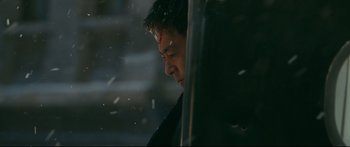 Movie still from “Cliff Walkers” (2021), directed by Yimou Zhang – A person looking out of a car window; Close Up shot, Low angle