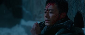 Movie still from “Cliff Walkers” (2021), directed by Yimou Zhang – A man with blood all over his face and head; Close Up shot, High angle
