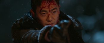 Movie still from “Cliff Walkers” (2021), directed by Yimou Zhang – A man with blood all over his face; Close Up shot, Low angle