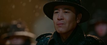 Movie still from “Cliff Walkers” (2021), directed by Yimou Zhang – A person wearing a hat; Close Up shot, Over the shoulder angle