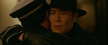 Movie still from “Cliff Walkers” (2021), directed by Yimou Zhang – A person wearing a hat; Close Up shot, Over the shoulder angle