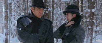 Movie still from “Cliff Walkers” (2021), directed by Yimou Zhang – A man and a woman wearing hats and coats; Medium shot, Over the shoulder angle
