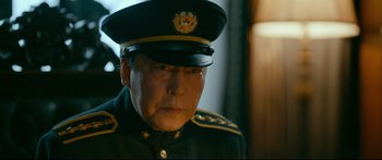 Movie still from “Cliff Walkers” (2021), directed by Yimou Zhang – An older man wearing a military uniform and a hat; Close Up shot, Over the shoulder angle