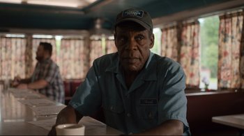 Movie still from “The Dead Don't Die” (2019), directed by Jim Jarmusch – An older man sitting at a table in a restaurant; Close Up shot, Over the shoulder angle