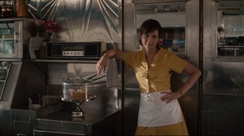 Movie still from “The Dead Don't Die” (2019), directed by Jim Jarmusch – A woman standing in front of an oven in a kitchen; Medium shot, Low angle