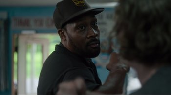 Movie still from “The Dead Don't Die” (2019), directed by Jim Jarmusch – A person wearing a hat; Close Up shot, Over the shoulder angle