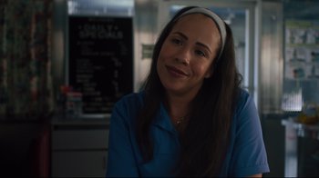 Movie still from “The Dead Don't Die” (2019), directed by Jim Jarmusch – A woman wearing a headband sitting in front of a menu; Close Up shot, Over the shoulder angle