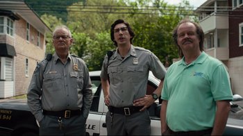 Movie still from “The Dead Don't Die” (2019), directed by Jim Jarmusch – A group of men standing next to each other near a police car; Medium shot, Low angle